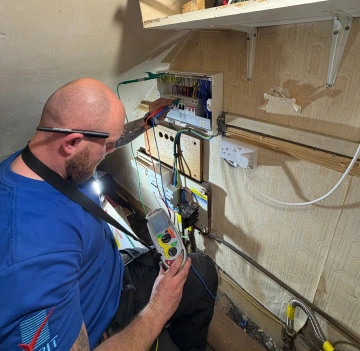 Domestic electrician carrying out home electrical work
