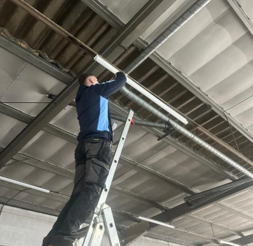 Electrician fitting a new light in South Wales