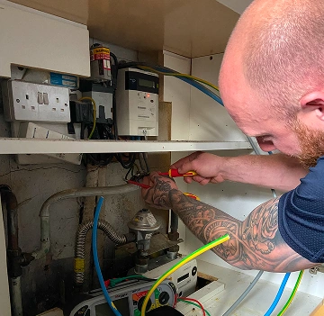 Commercial electrician carrying out electrical work