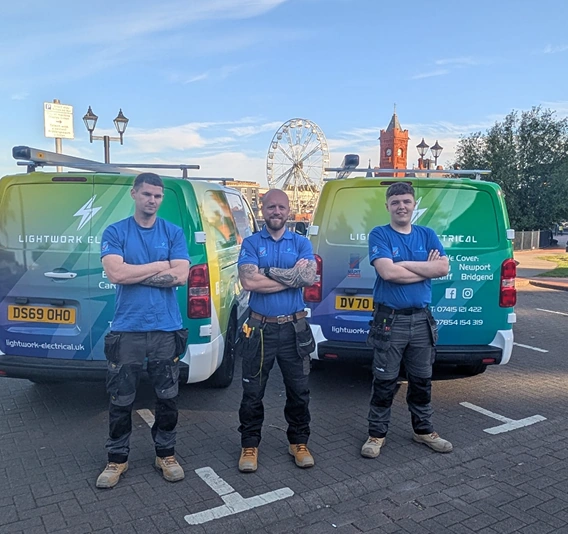 Lightwork Electrical team in front of company vans