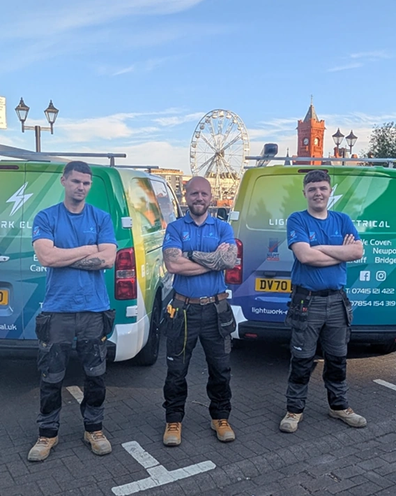 Lightwork Electrical team in front of company vans