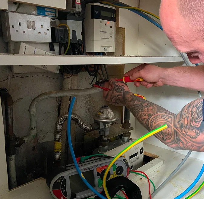 Commercial electrician carrying out electrical work